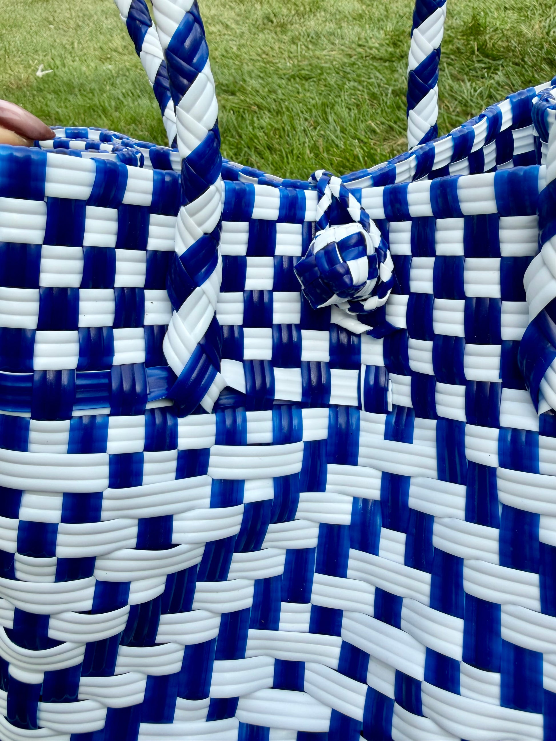 Close-up of a blue and white checkered bag with woven pattern.
