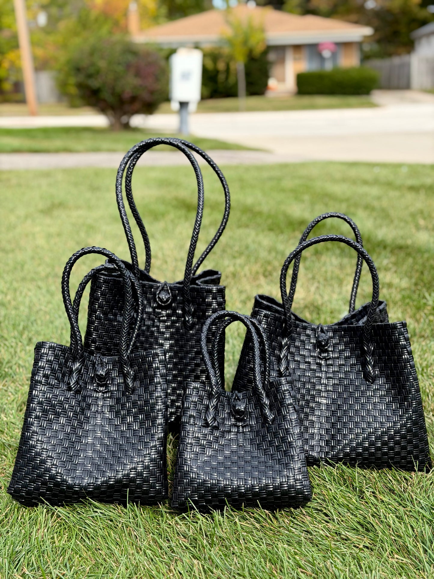 The Blackout Luxe handwoven recycled tote bag in black — sustainable and waterproof.
