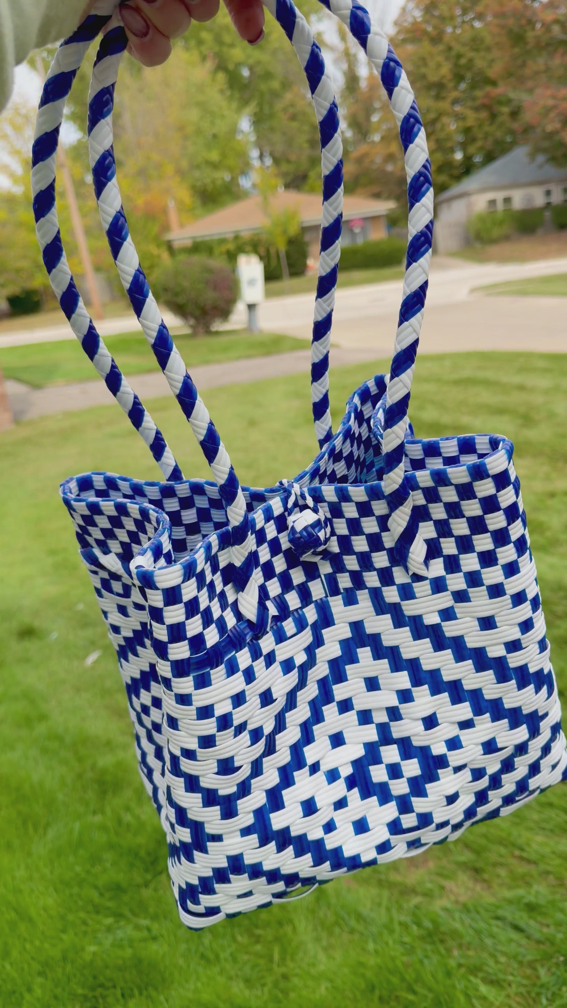 Sustainable recycled plastic tote bag in blue and white pattern on grass.
